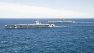 The aircraft carrier USS Enterprise (CVN 65) passes the aircraft carrier USS Harry S. Truman (CVN 75) in the Atlantic Ocean. (U.S. Navy photo by Naval Aircrewman (Tactical Helicopter) 3rd Class Matt Ballard/Released) 
