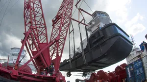 As the crane swing on its 60-foot diameter ring, the tug had to be lifted to clear winches and containers on the barge deck. (Photo: Haig-Brown / Cummins)
