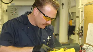 Cutter engineer receives immediate oil analysis results (Photo courtesy USCG)