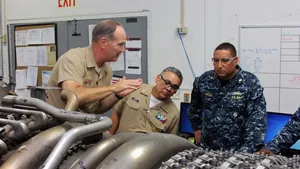 Capt. James S. Talbert, production officer at Norfolk Ship Support Activity, explains the change-out process of an LM2500 gas turbine engine to Rear Adm. Gregorio Martinez Nunez, Director of Mexican Navy General Staff, as Lt. Cmdr. Vargas interprets. (U.S. Navy photo by Art B. Ladle)