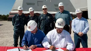 Jonathan Graves (sitting, left) and John Fillmore (sitting, right) sign the delivery documents: Photo credit HII 