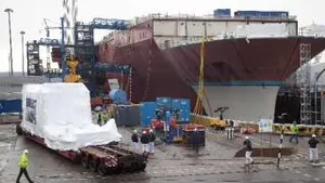 The Rolls-Royce MT30 gas turbine enclosure, shrink wrapped for protection, arrives alongside HMS Queen Elizabeth, prior to installation at Babcock’s Rosyth yard in Scotland.