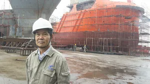 Xin Yue Feng Shipyard’s Chairman Luo Chaoneng with a pair of AHTs under construction.