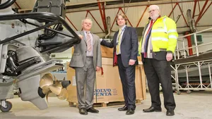 Bob Troop, chair and managing director James Troop & Co (in hi-vis jacket); Anthony Ward, engine sales executive James Troop & Co (grey suit); and Philip Hilbert, sales director MST (blue suit); seen with one of the new vessels at MST's construction facility and HQ, at Atlantic Way, Liverpool. (Photo: James Troop)