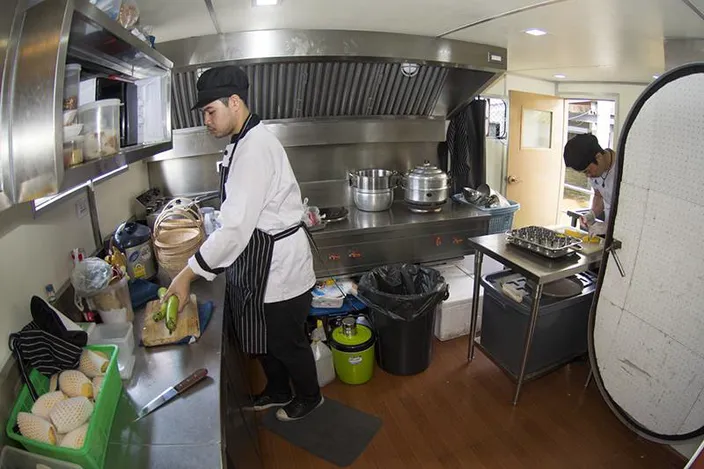 Chefs prepare dinner for up to 90 guests in the well laid out and equipped galley. (Photo: Haig-Brown/Cummins)