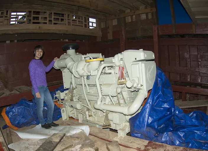 Cummins Vietnam Engine Sales Engineer Linh Cam Nguyen inspects the KTA19 main engine. (Haig-Brown photos courtesy of Cummins Marine)