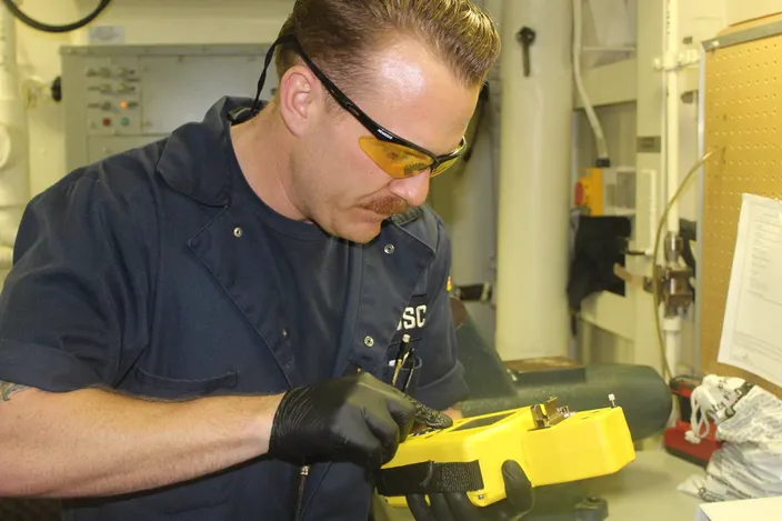 Cutter engineer receives immediate oil analysis results (Photo courtesy USCG)