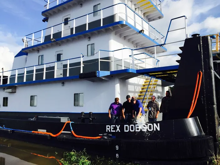 Rex Dobson breaking the traditional bottle over his namesake (Photo: New Generation Shipbuilding)