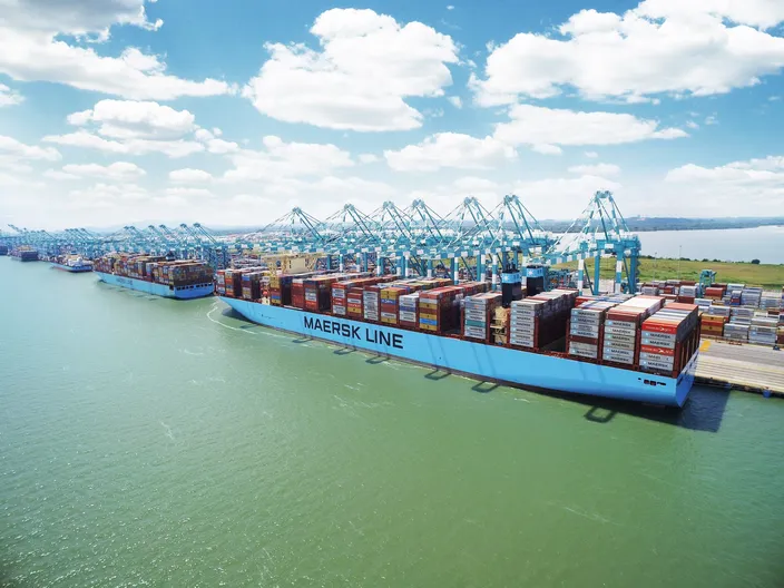 File Image: A typical Maersk boxship works cargo alongside a pier. (CREDIT: Maersk)