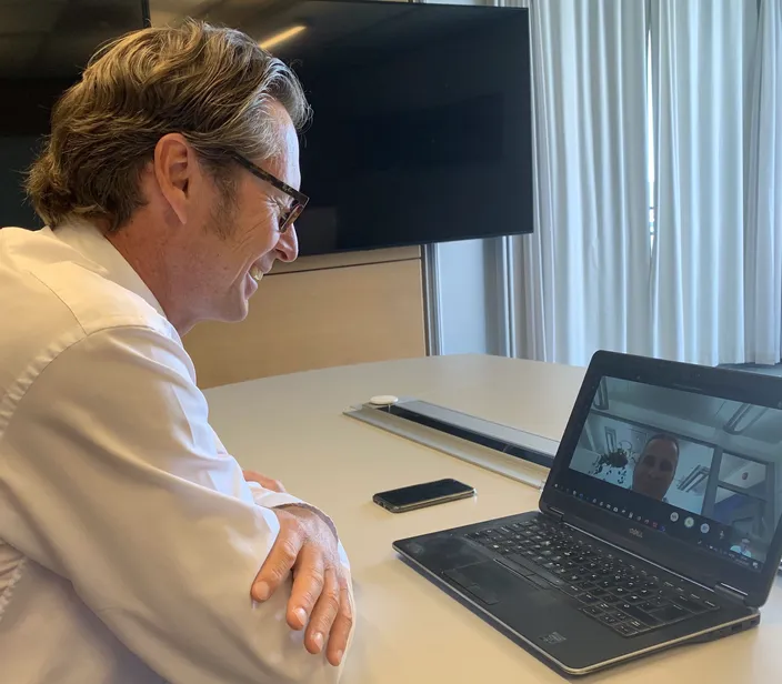DNV GL - Maritime CEO Knut Ørbeck-Nilssen (left), speaks with Juha Koskela, Managing Director, ABB Marine & Ports, via laptop at the signing. (Photo: DNV GL)