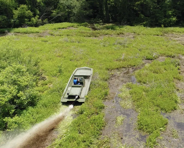 Metal Shark 21 Riverine equipped with Swamp Shark surface drive, shown powering through vegetation in Louisiana’s Atchafalaya Basin (Photo: Metal Shark)