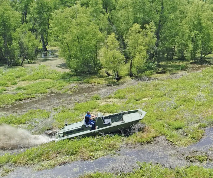 Metal Shark 21 Riverine equipped with Swamp Shark surface drive, shown powering through vegetation in Louisiana’s Atchafalaya Basin (Photo: Metal Shark)