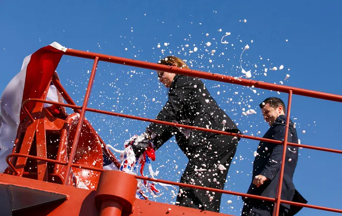 Pamela Beall breaks a of champagne across the hull to christen Ohio (Photo: Crowley)