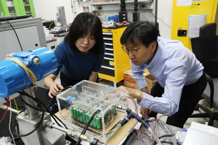 Research team at KIMM’s Heat Pump Research Center (Dr. Jinsub Kim pictured on the left)Dr. Jinsub Kim at KIMM operates the spray-based immersion cooling chamber.  Image Copyright KIMM