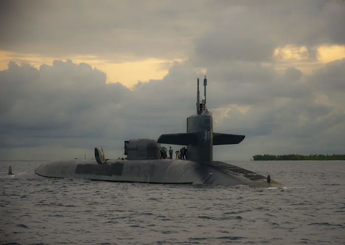 Sailors aboard the guided-missile submarine USS Georgia (SSGN 729) prepare to dock at U.S. Navy Support Facility Diego Garcia in British Indian Ocean Territory, December 2013 (U.S. Navy photo by Alex Smedegard)