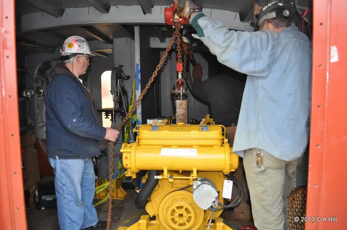 At Senesco Marine, workers load the Caterpillar C-12 main engines from Milton Cat onto the SSV Oliver Hazard Perry. (Photo Credit: OHPRI/Carol Hill)
