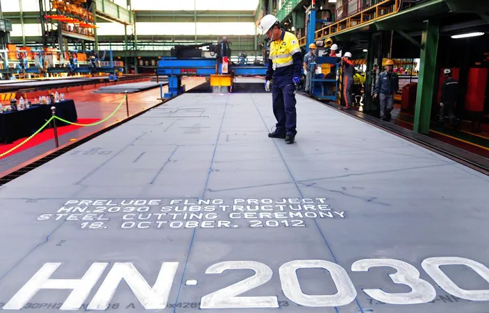 Shell celebrates the first steel cut for the first steel cut for the game-changing Prelude floating liquefied natural gas project’s substructure. The sheet of steel to be cut weighs 7.6 tonnes, is 4.3 metres wide, 13.8 metres long and 16.5 millimetres thick. (Photo: Shell)   