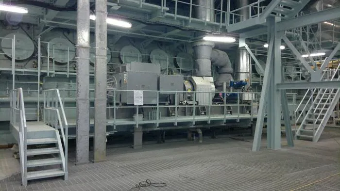 A TCS-PTG22 unit pictured adjacent to the MAN B&W 12K80MC-S engine at the Miraflores power Plant in Panama
