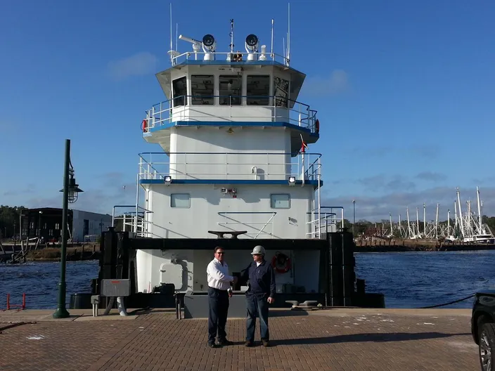 Travis R. Short of Horizon Shipbuilding with Jeff Brumfield of FMT in front of newbuild M/V Michael Akiu #86  (Photo: Horizon Shipbuilding)
