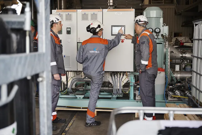 Wärtsilä Exhaust Treatment's engineers examine CCS performance in the company's test hall in Moss, Norway. © Wärtsilä